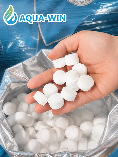 Close-up of Aqua-Win white salt tablets for water softener systems, designed for brine tanks and stable soft water performance.
