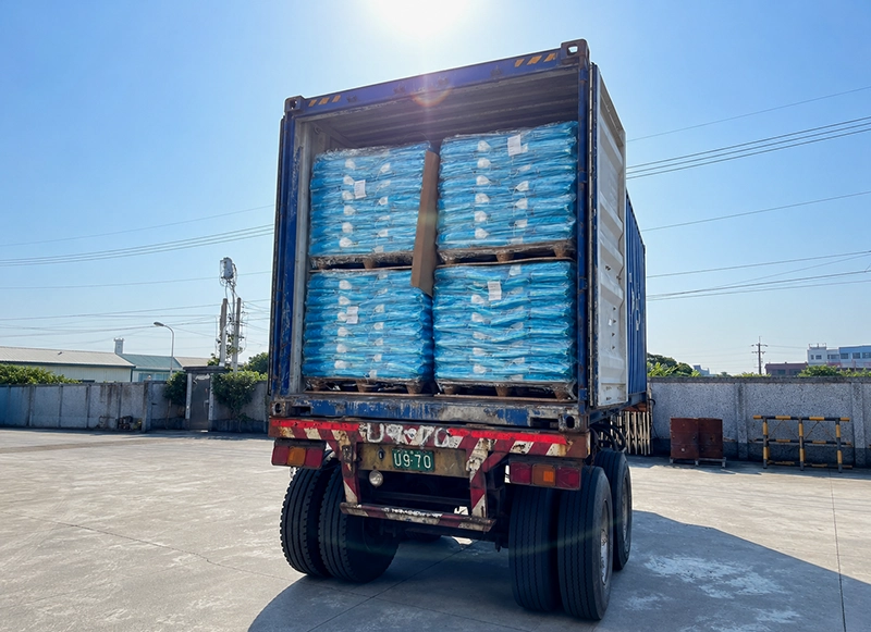Aqua-Win water softener salt tablets arranged on pallets for truck delivery, suitable for wholesale and commercial water softener supply.